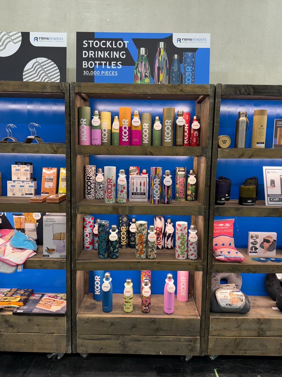 Beursstand van Firma Reinders met de stocklot KOOR-drinkflessen in de schappen